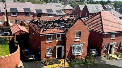 Moment solar panels on £600k house go up in flames with family inside | SWNS
